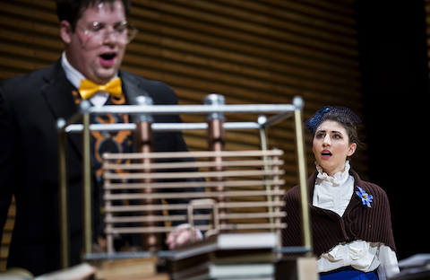 Ada Lovelace (played by Helen Hass) attempts to command the attention of Charles Babbage (Zach Crowle) as he obsesses over his Analytical Engine.